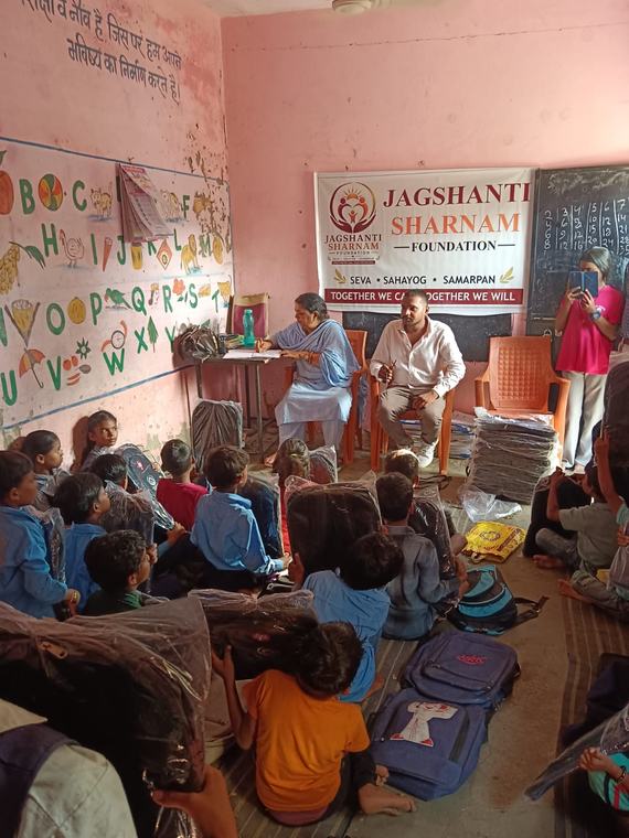 Foundation team in the classroom with the banner behind them while children listen (photo 8 of 10)