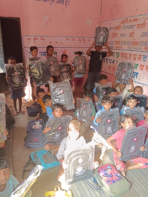 Children in the classroom holding up their new school bags (photo 5 of 10)